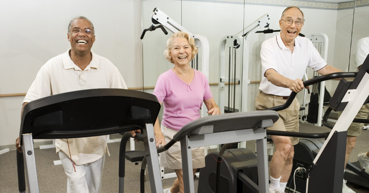 Is Sitting Too Much Bad for Your Brain? Picture of an elderly black male, an elderly caucasian female and an elderly caucasian male all walking on treadmills.