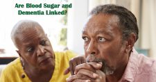 Is There a Link Between Blood Sugar and Dementia? Picture of a black female looking concerned about an elderly black male who looks lost in thought.